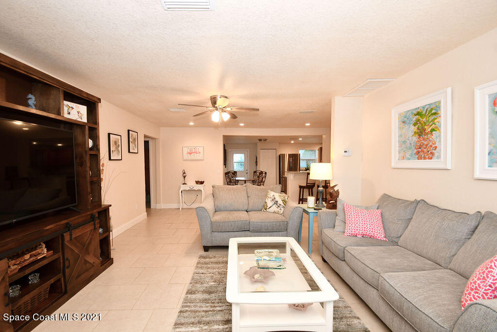 1461 Creel Road Northeast Palm Bay, FL 32905 - Photo 6 of 20 a living room with furniture and a flat screen tv