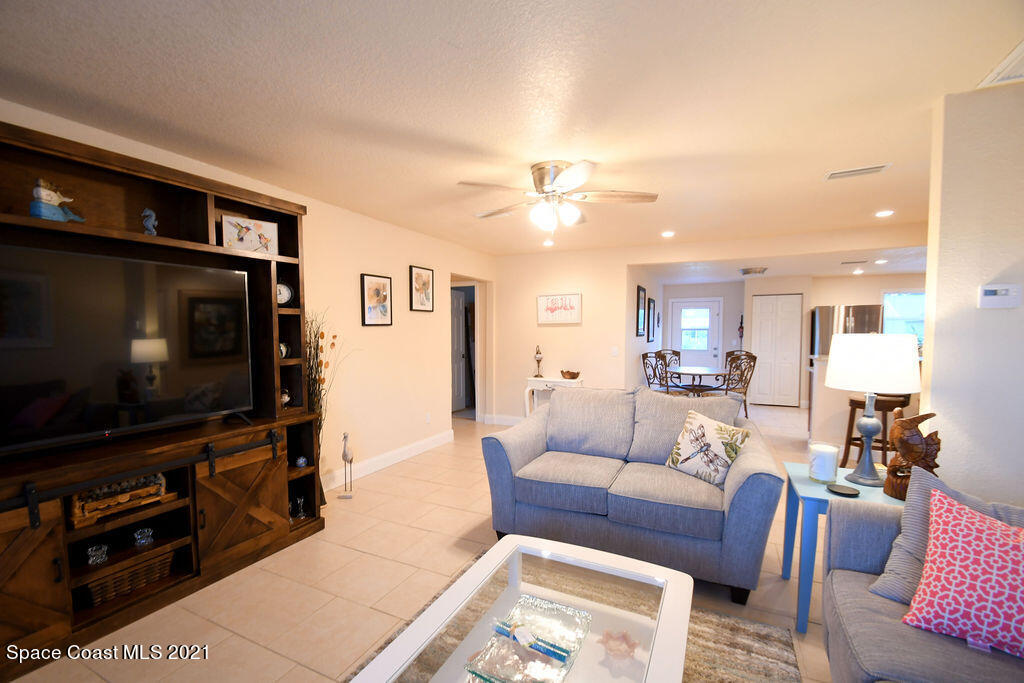 1461 Creel Road Northeast Palm Bay, FL 32905 - Photo 7 of 20 a living room with furniture and a flat screen tv