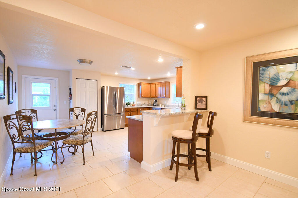 1461 Creel Road Northeast Palm Bay, FL 32905 - Photo 10 of 20 a dining room with furniture and a painting