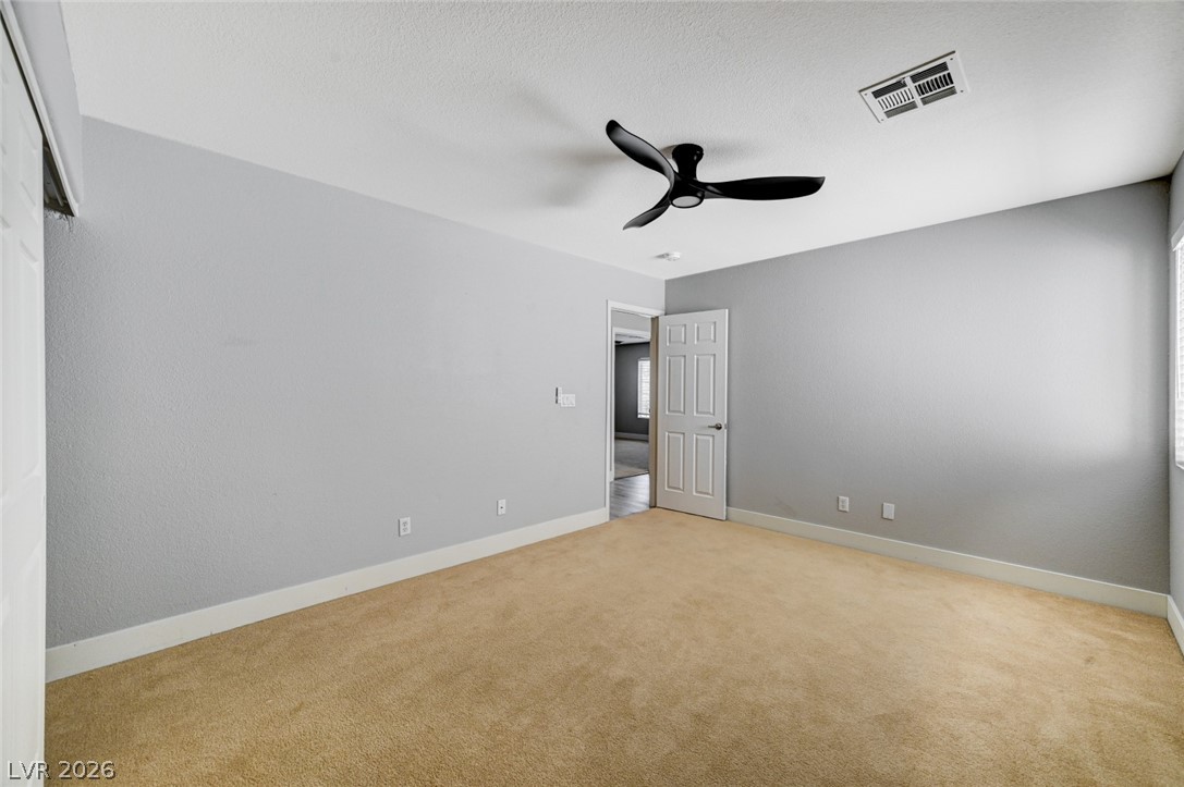 7259 Cestrum Road Las Vegas, NV 89113 - Photo 20 of 35 A quiet retreat, this inviting bedroom features a contemporary ceiling fan and soft carpeting.
