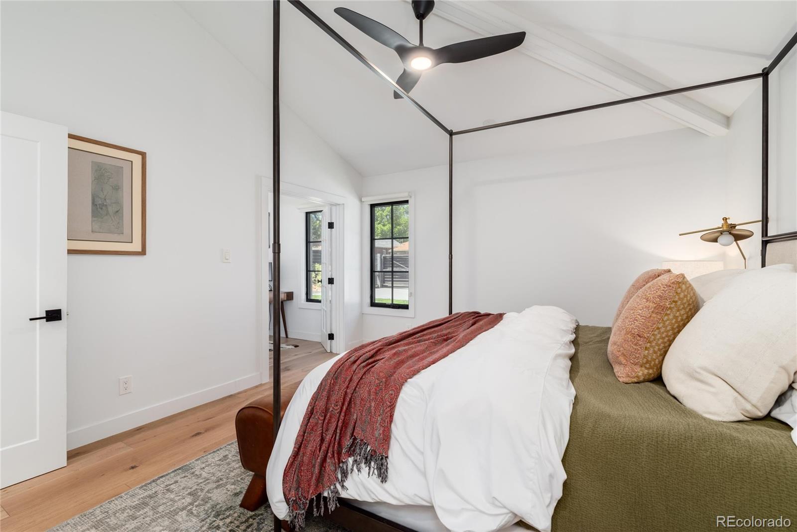 1065 South Monroe Street Denver, CO 80209 - Photo 14 of 32 a bedroom with a bed and wooden floor