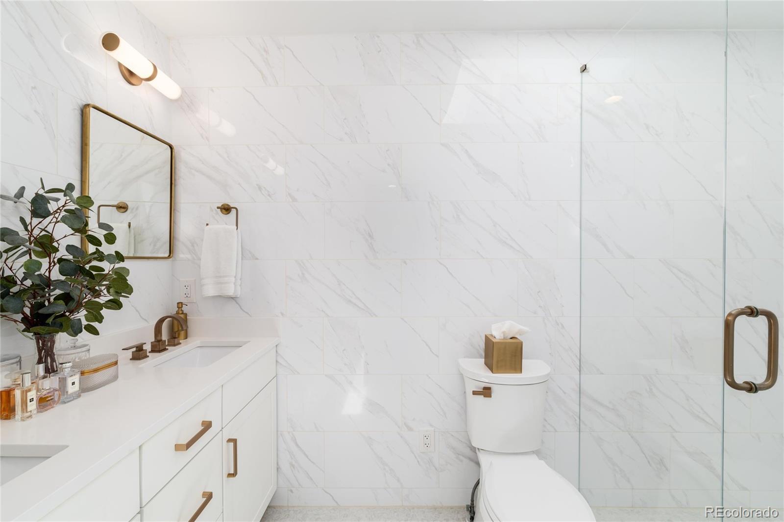 1065 South Monroe Street Denver, CO 80209 - Photo 16 of 32 a bathroom with a sink vanity granite and toilet