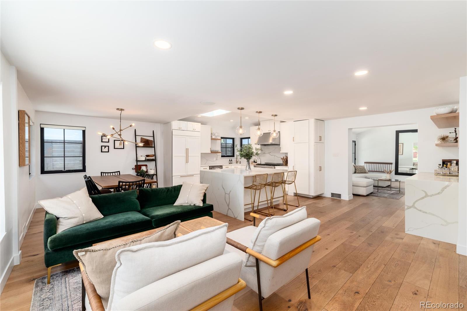1065 South Monroe Street Denver, CO 80209 - Photo 2 of 32 a living room with furniture and kitchen view