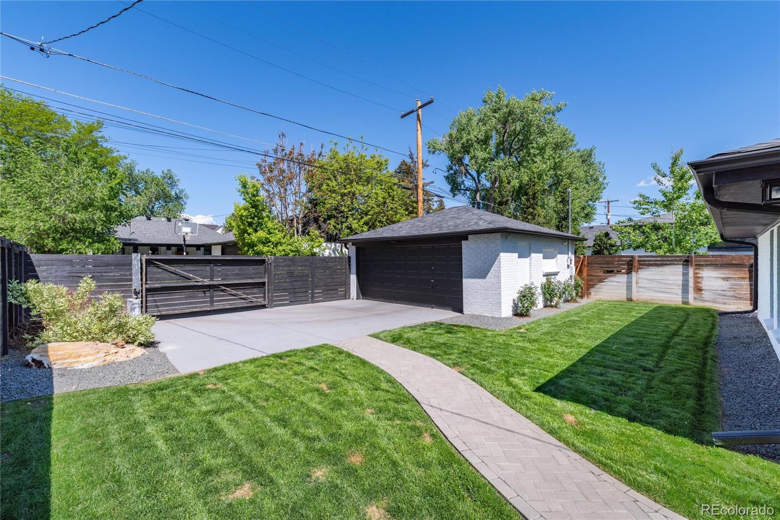 1065 South Monroe Street Denver, CO 80209 - Photo 27 of 32 a front view of a house with a yard