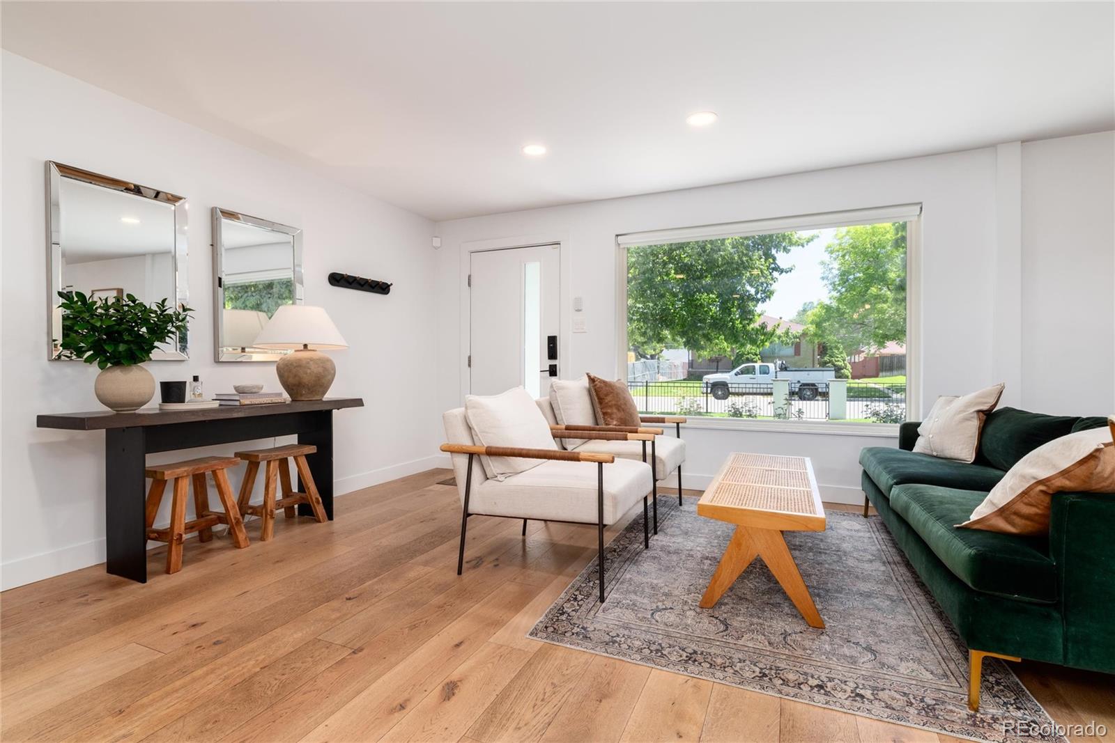 1065 South Monroe Street Denver, CO 80209 - Photo 3 of 32 a living room with furniture and a large window