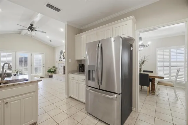 a kitchen with stainless steel appliances a refrigerator sink and cabinets