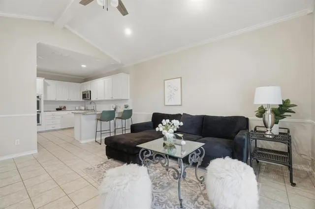 a living room with furniture and kitchen view