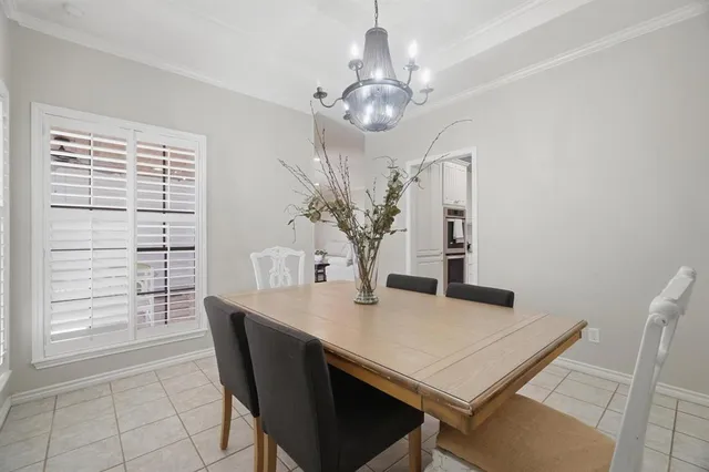 a view of a dining room with furniture and chandelier