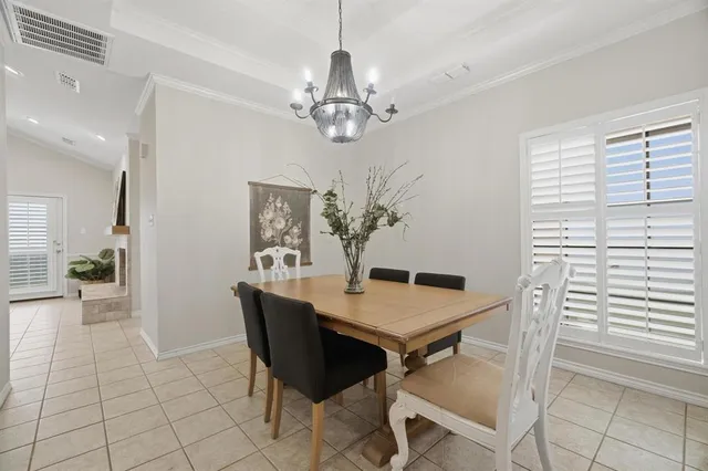 a view of a dining room with furniture and a chandelier