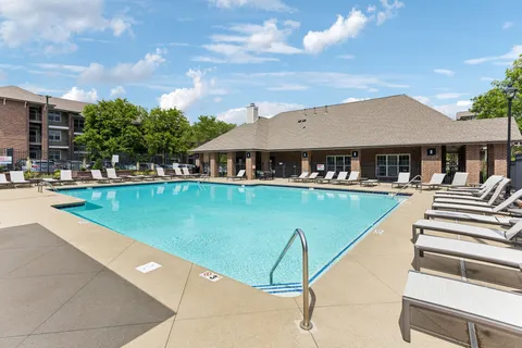 a view of a patio with swimming pool and furniture