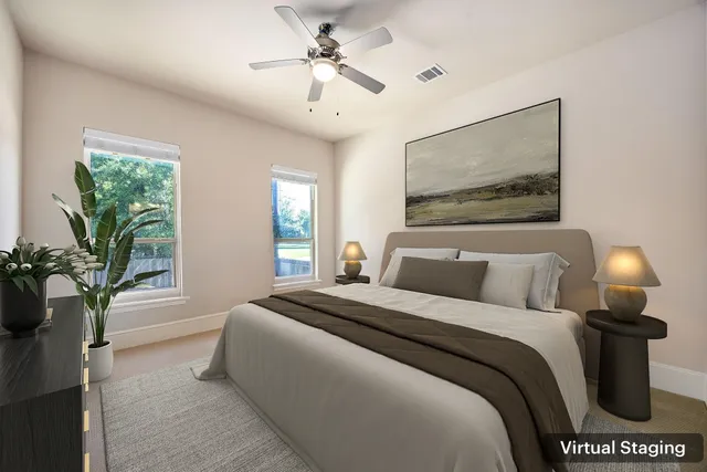 a bedroom with a bed and a potted plant