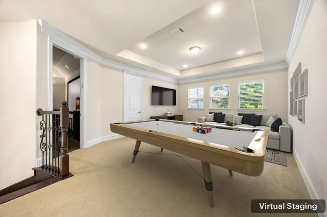 a living room with a table chairs and a flat screen tv