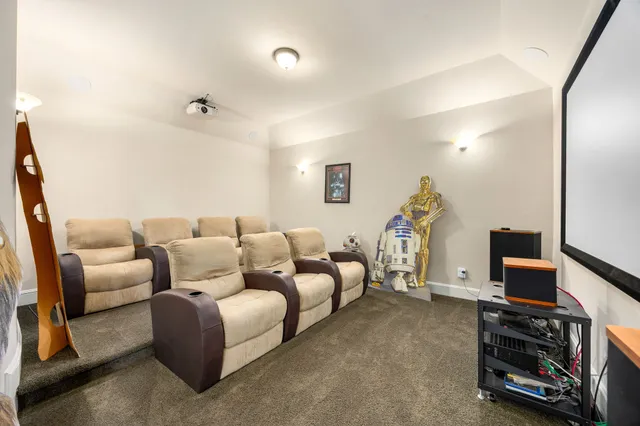a living room with furniture a flat screen tv and a couch