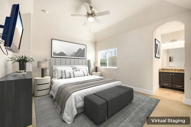 a bedroom with a bed a flat screen tv and dresser