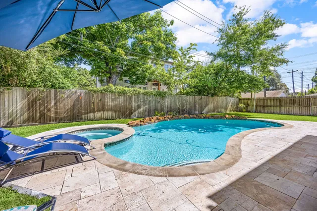a view of swimming pool with a patio