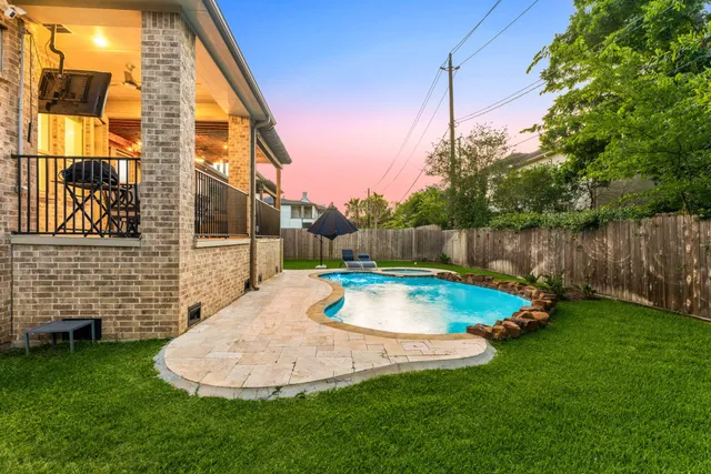 a backyard of a house with table and chairs
