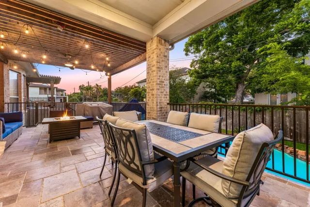 a view of a patio with a table and chairs