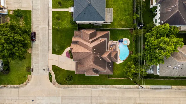 an aerial view of a house with a garden and trees