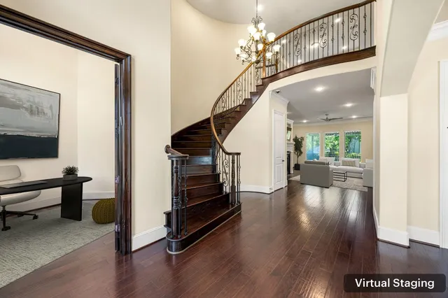 a view of a livingroom with wooden floor and stairs