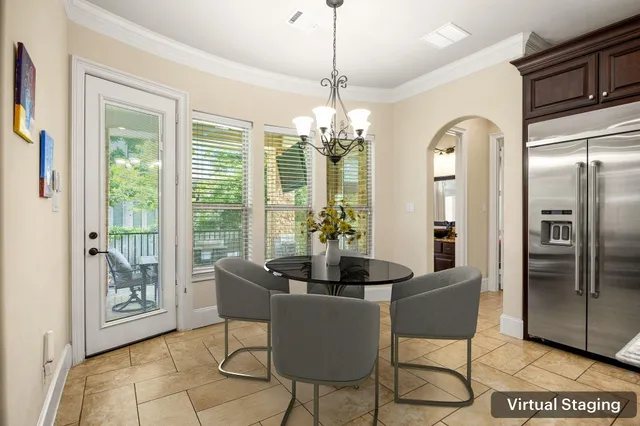 a dining room with furniture a chandelier and wooden floor