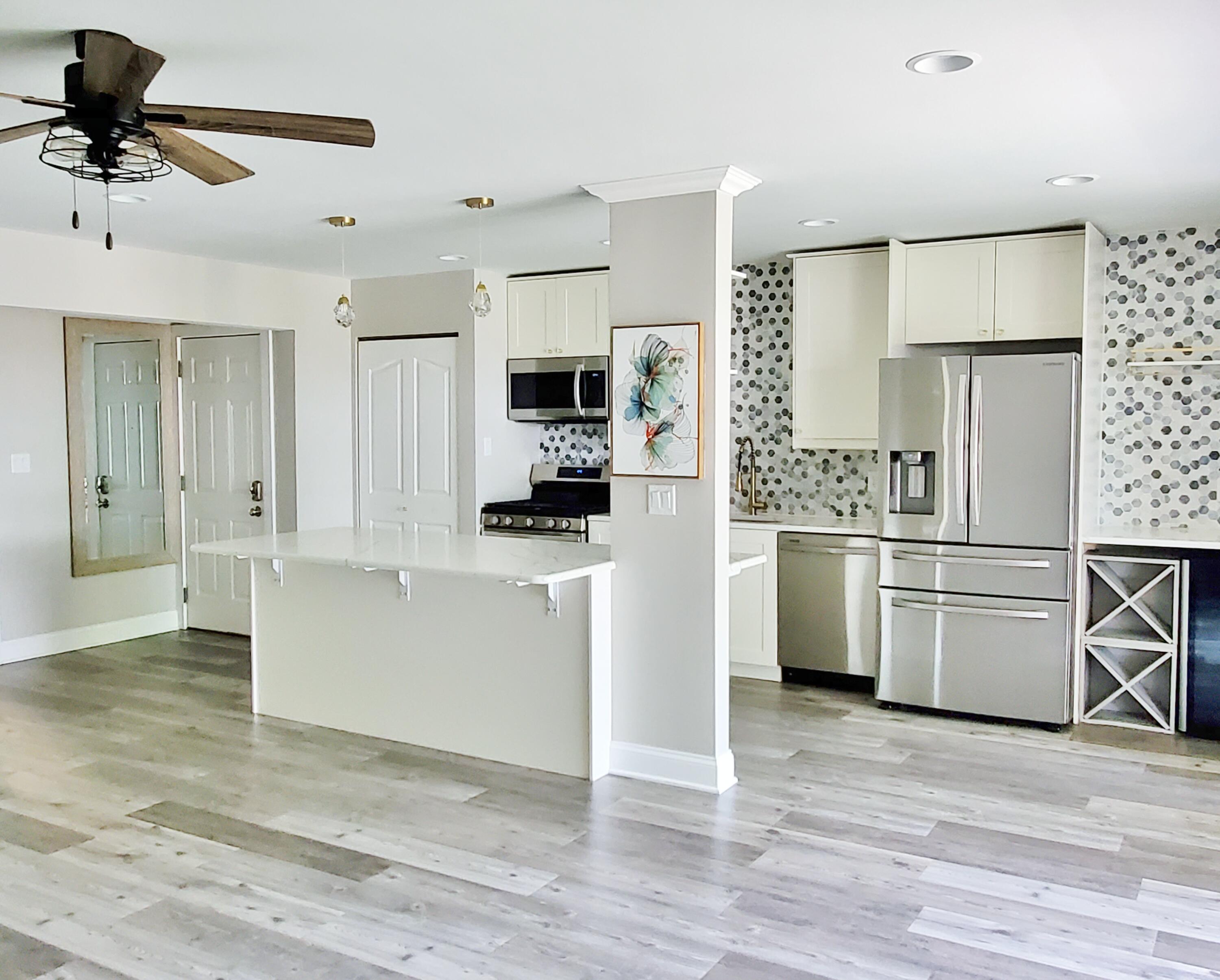 514 Birch Tree Lane Michigan City, IN 46360 - Photo 3 of 23 a kitchen with white cabinets and stainless steel appliances