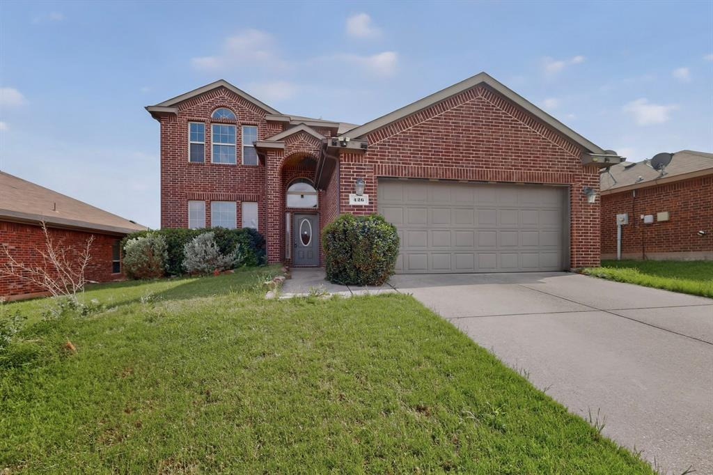 426 Harding Lane Lavon, TX 75166 - Photo 2 of 40 Brick facade residence featuring an arched entryway, multiple front-facing windows, an attached two-car garage, concrete driveway, and front landscaping