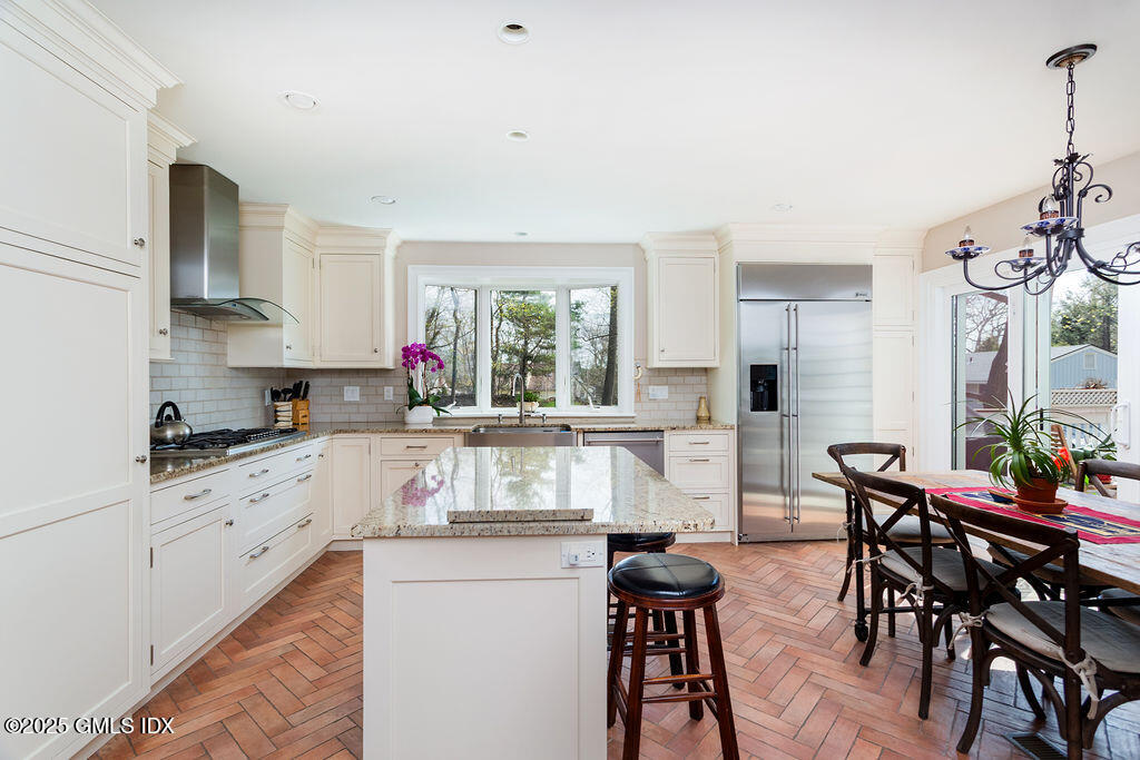 19 Stanwich Road Greenwich, CT 06830 - Photo 11 of 32 a kitchen with stainless steel appliances granite countertop a kitchen island hardwood floor sink stove dining table and chairs