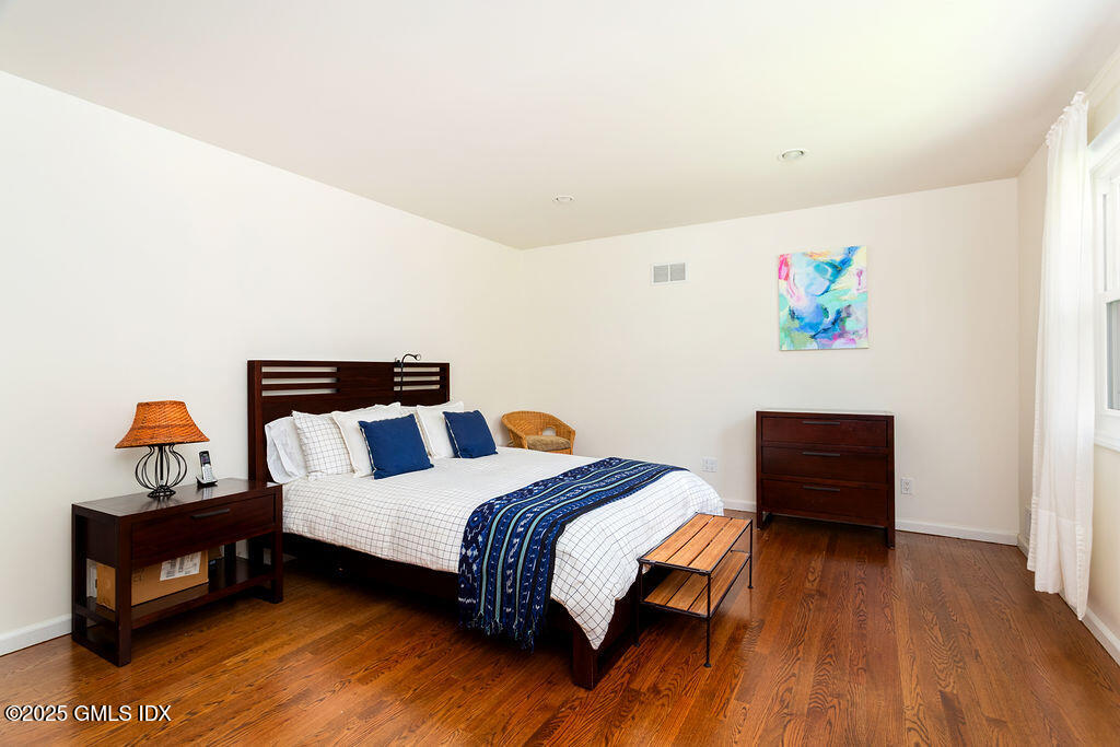 19 Stanwich Road Greenwich, CT 06830 - Photo 14 of 32 a bedroom with a bed and wooden floor