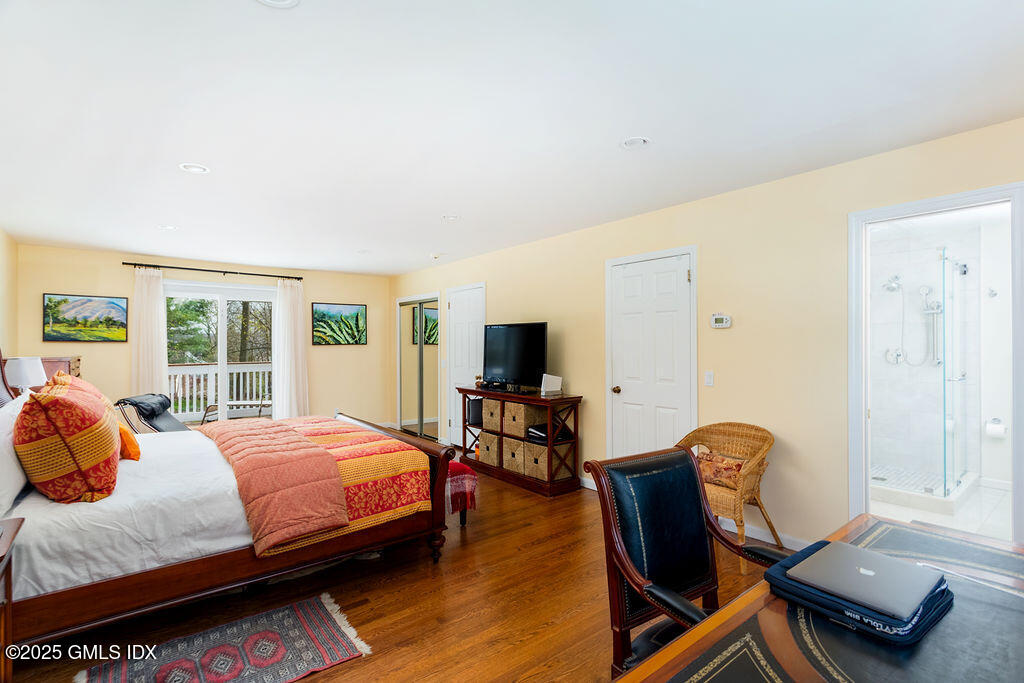 19 Stanwich Road Greenwich, CT 06830 - Photo 16 of 32 a bedroom with a bed and wooden floor