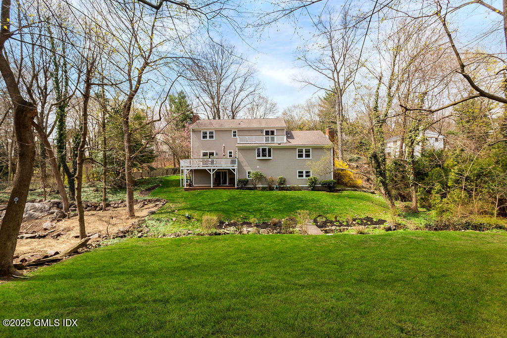 19 Stanwich Road Greenwich, CT 06830 - Photo 28 of 32 a view of a white house with a big yard and large trees