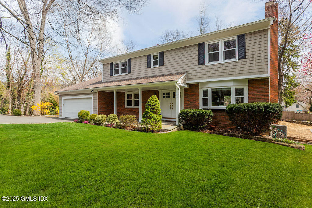 19 Stanwich Road Greenwich, CT 06830 - Photo 3 of 32 a view of a house with a yard and a large tree
