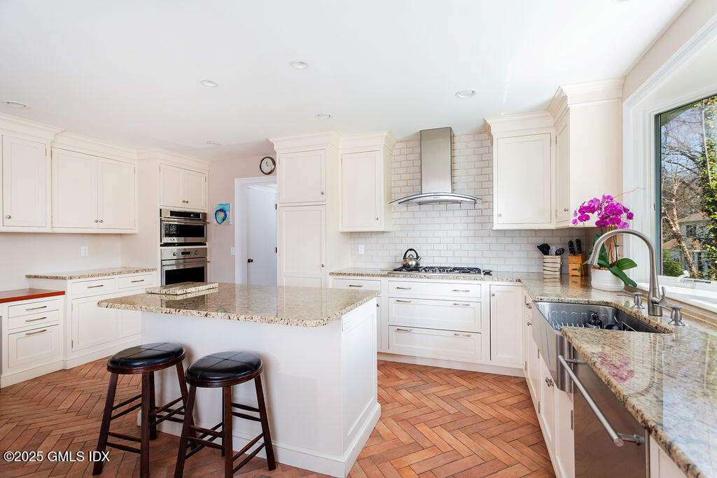 19 Stanwich Road Greenwich, CT 06830 - Photo 10 of 32 a kitchen with stainless steel appliances granite countertop a stove refrigerator sink and cabinets