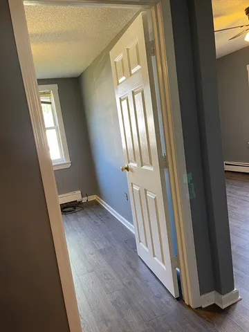a view of a livingroom with wooden floor and staircase