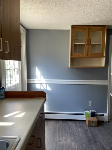 a view of room with window and wooden floor