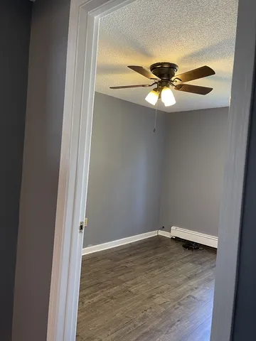 a view of room with wooden floor