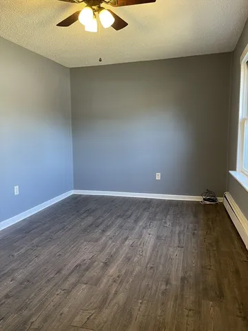 a view of a room with wooden floor and a window
