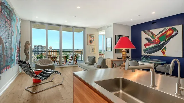 a living room with furniture and a book shelf