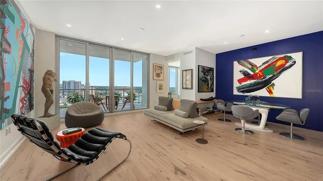 a dining room with furniture and a painting on the wall