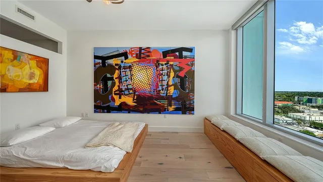 a view of a workspace with furniture and a window