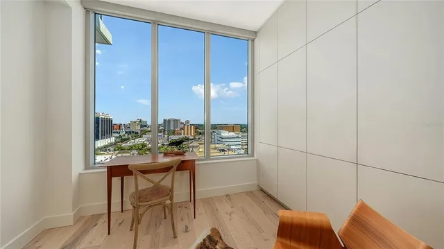 a view of a patio with a table and chairs and potted plants