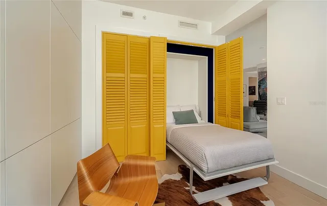 a view of a balcony with furniture and a potted plant