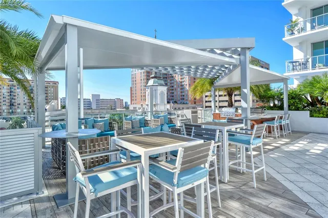 a view of patio with a table and chairs under an umbrella