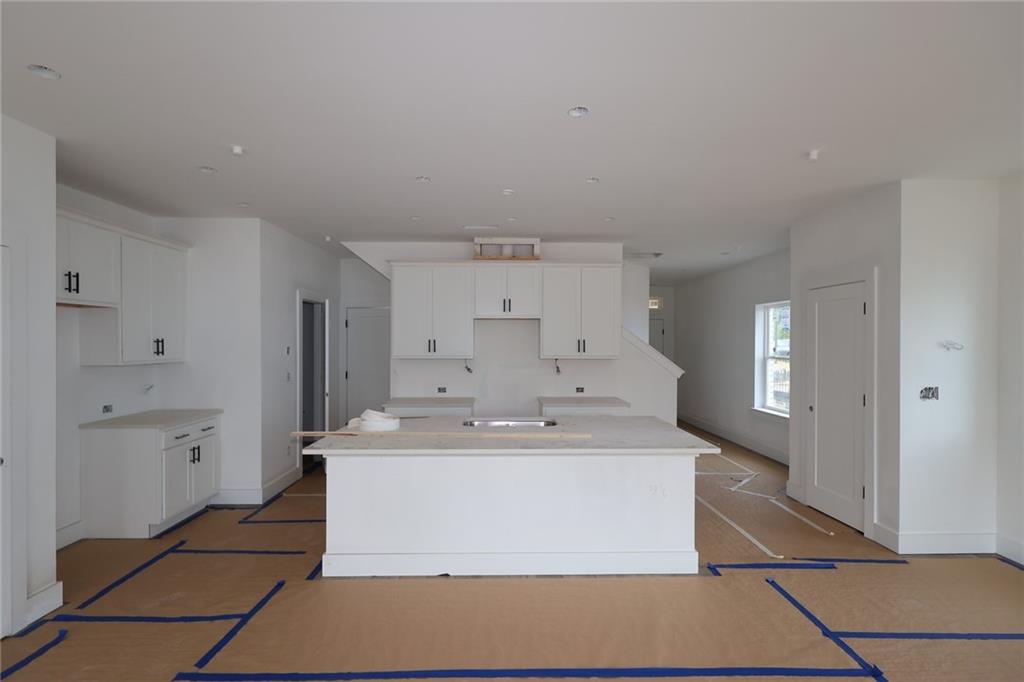 230 Redbud Road Canton, GA 30114 - Photo 6 of 11 a large white kitchen with a sink and refrigerator