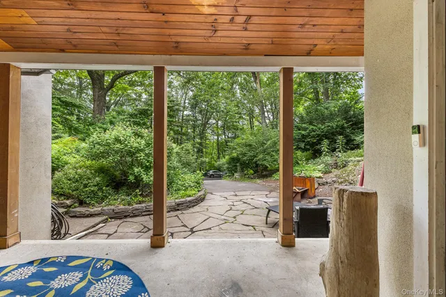 a view of a porch with a table and chairs
