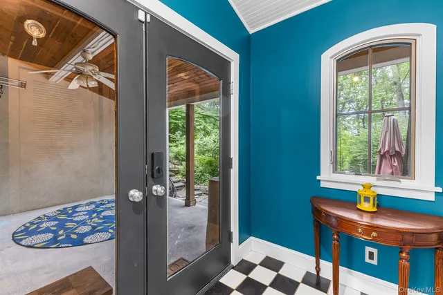 a view of hallway with furniture and a window
