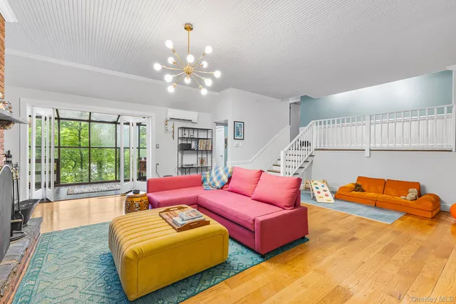 a living room with furniture and a chandelier