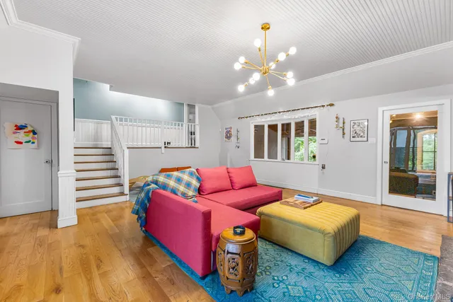 a living room with furniture and a chandelier
