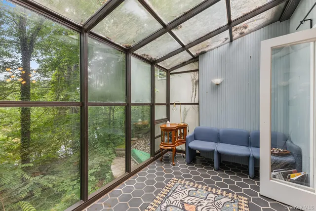 a living room with furniture and a dining table