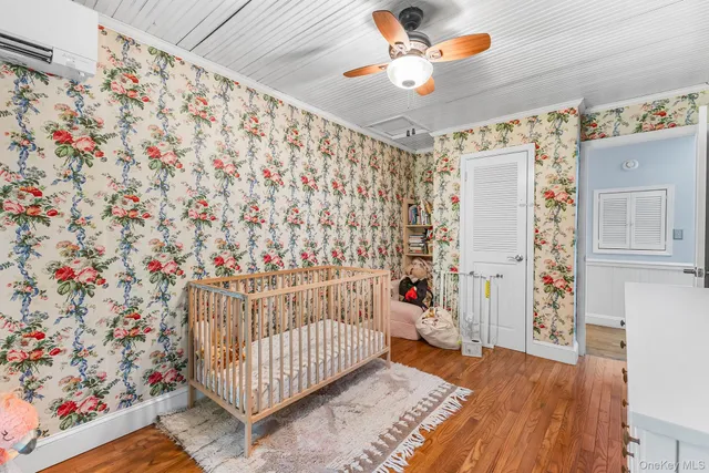 a bedroom with a bed a window and potted plant