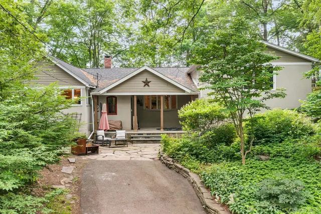a front view of a house with a yard garage and outdoor seating
